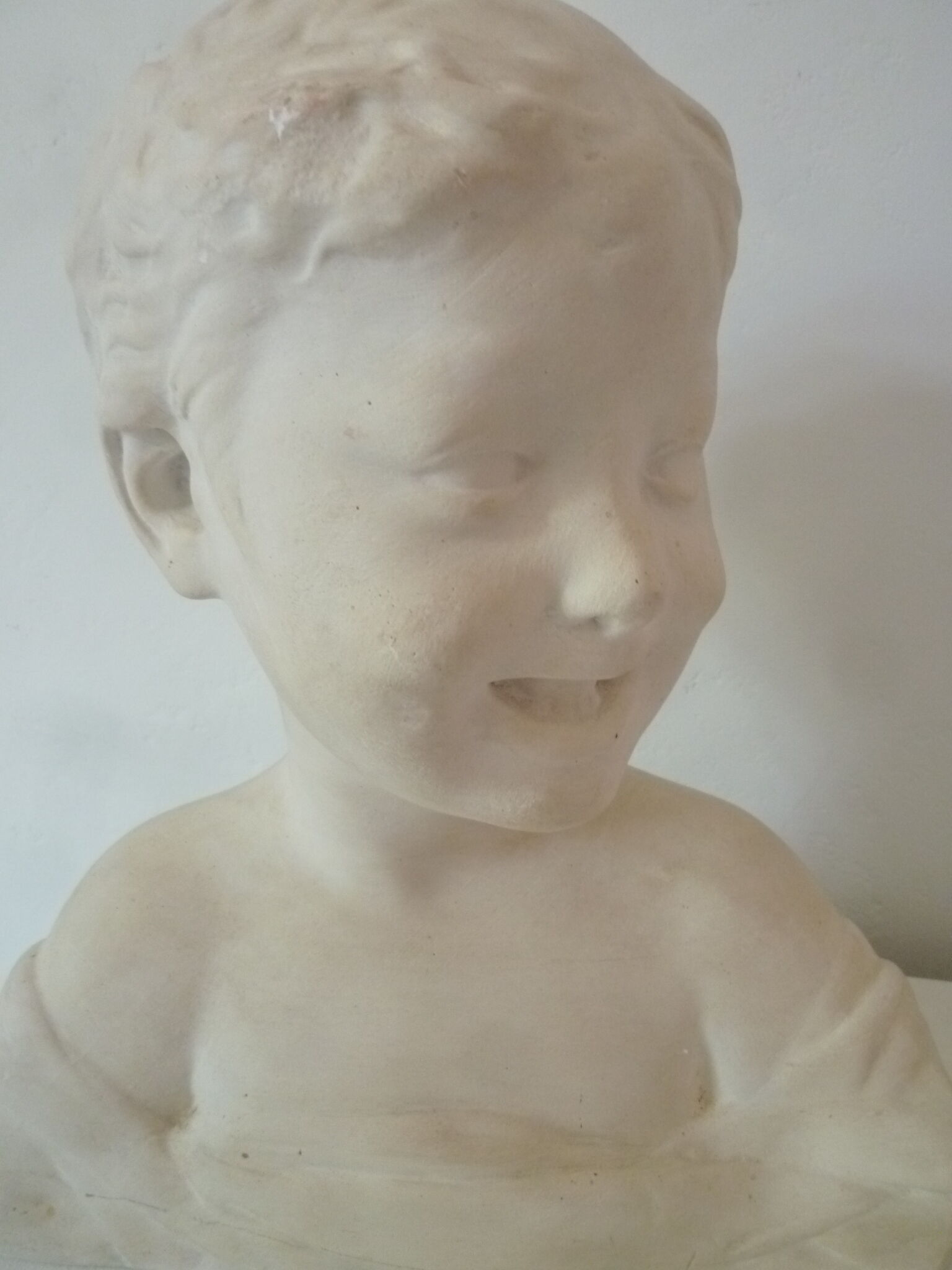 Bust young boy in plaster