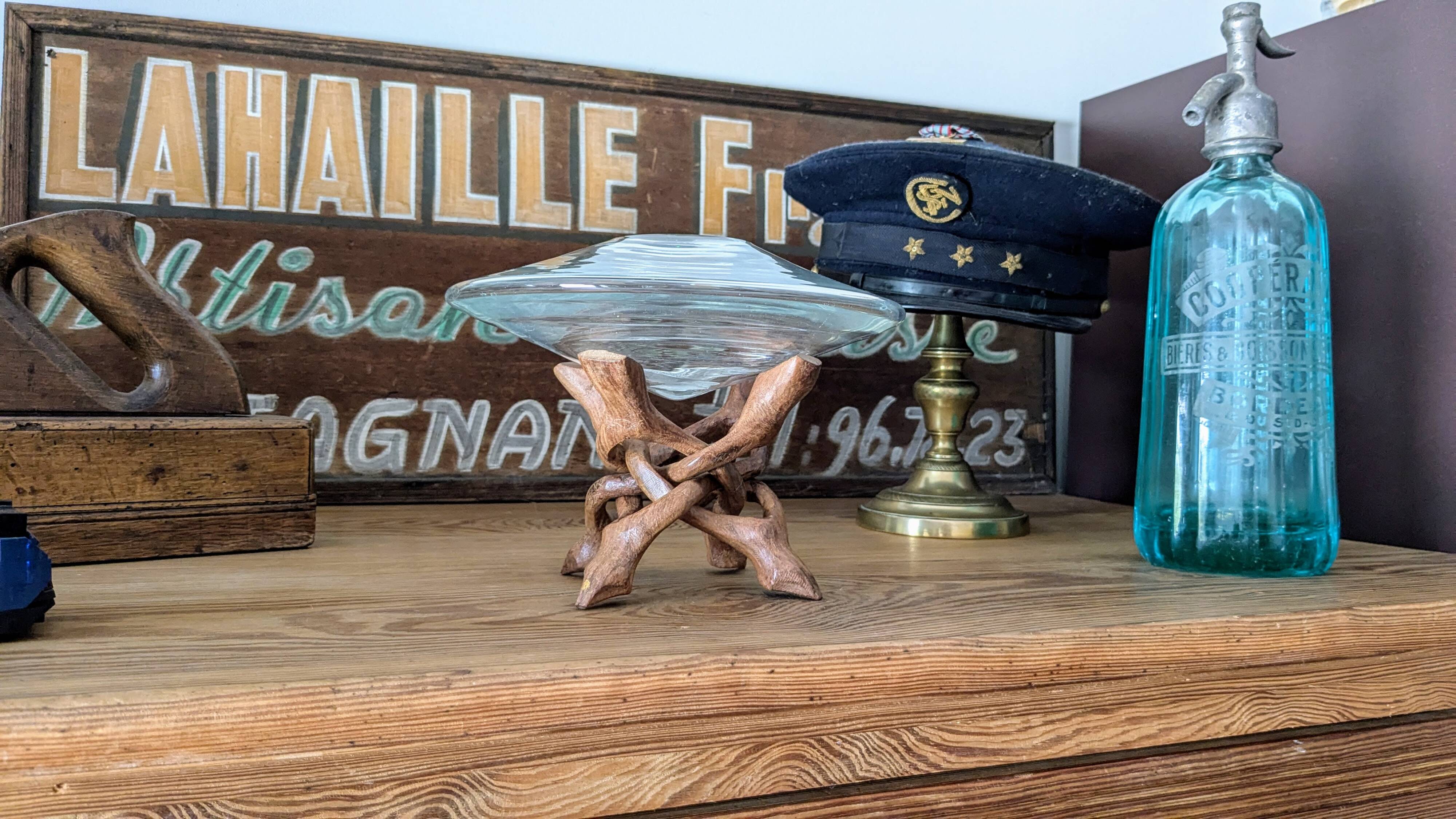 Glass cup molded on carved exotic wood