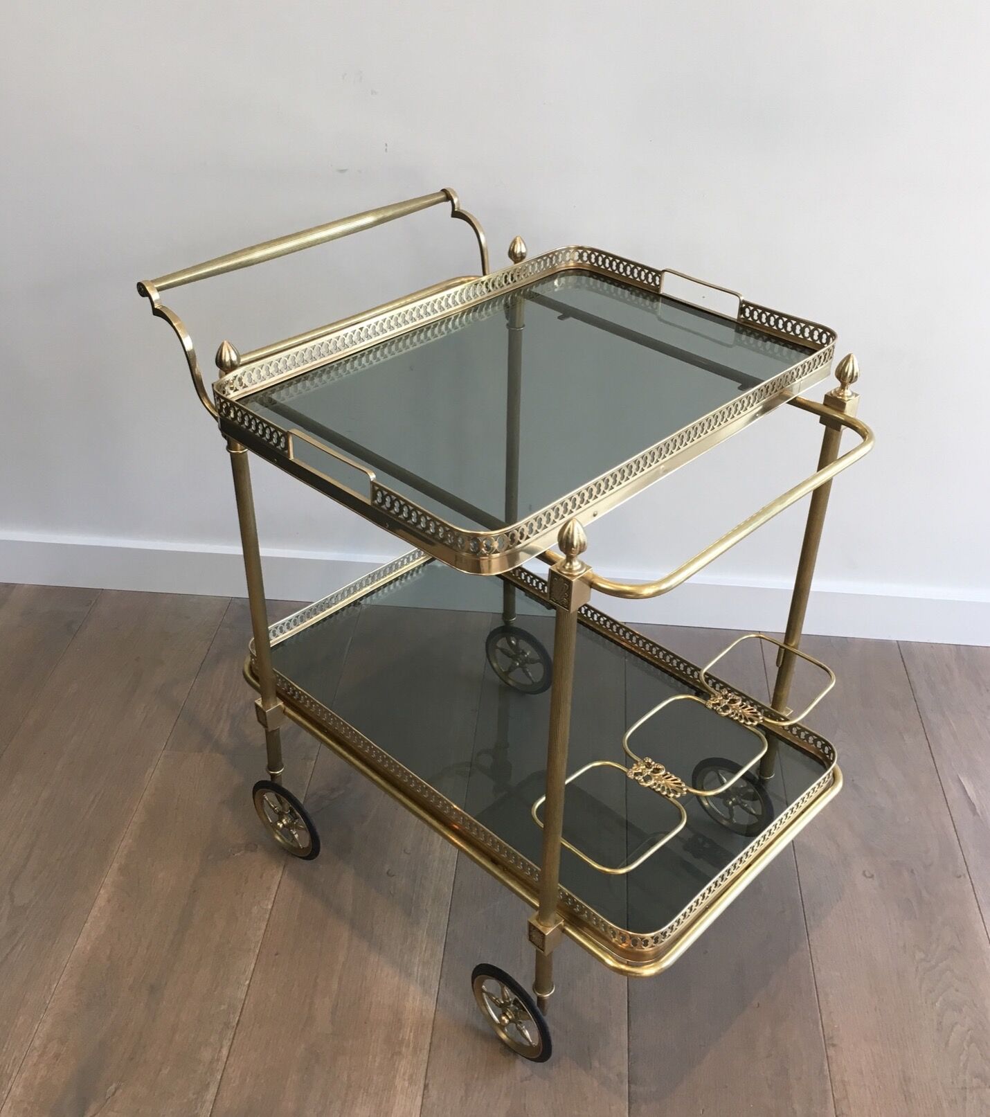 Neoclassical style rolling table in brass with blue glass tops