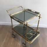 Neoclassical style rolling table in brass with blue glass tops