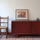 Teak enfilade, sliding doors, black faux leather top, 1970s.