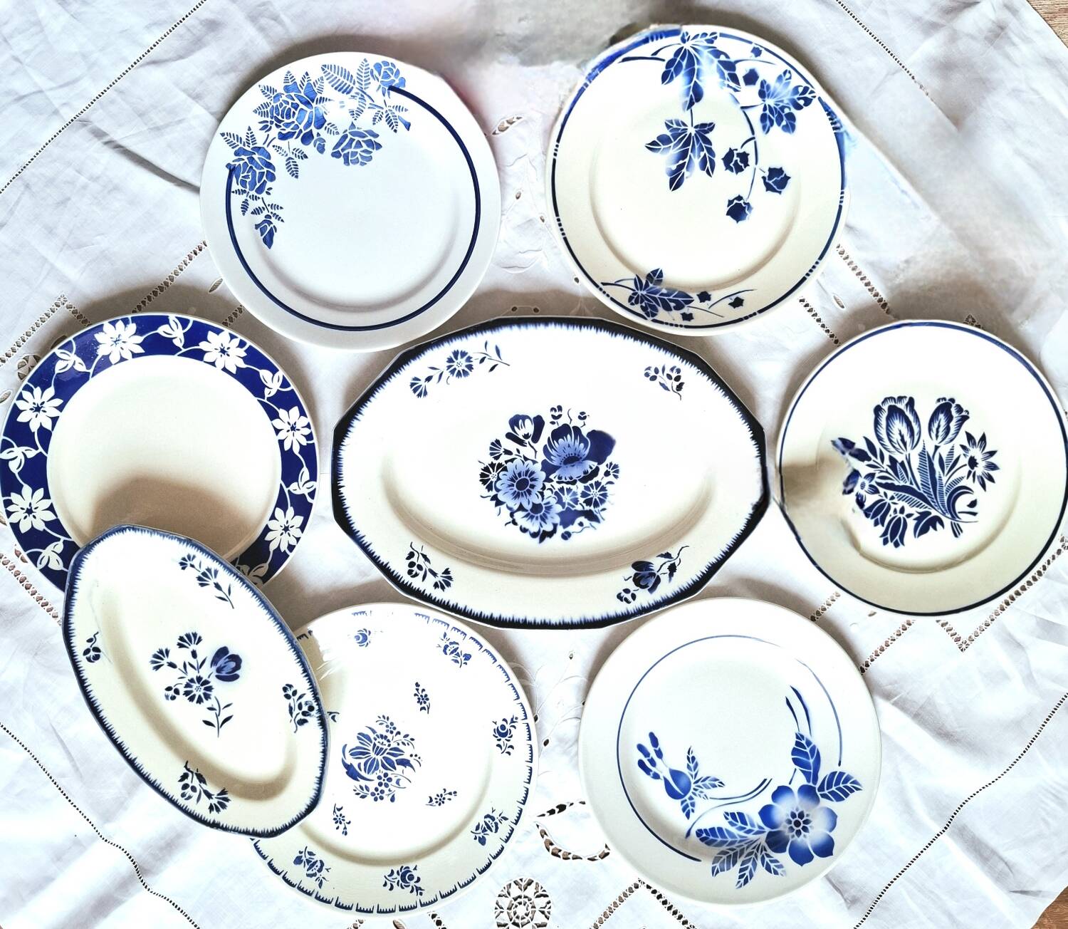 Mismatched antique flat plates accompanied by dishes.