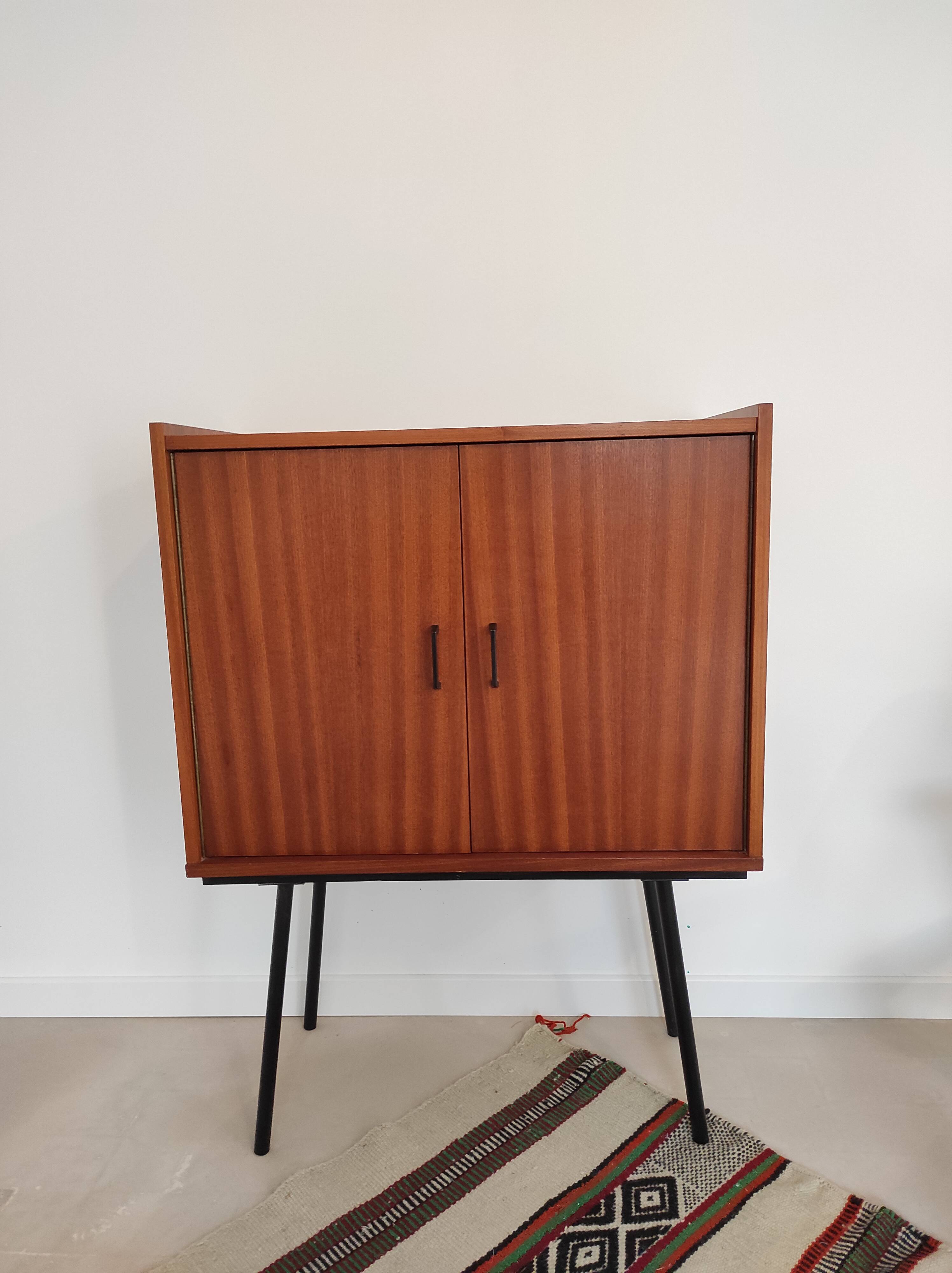 Piece of furniture on high feet metal compass