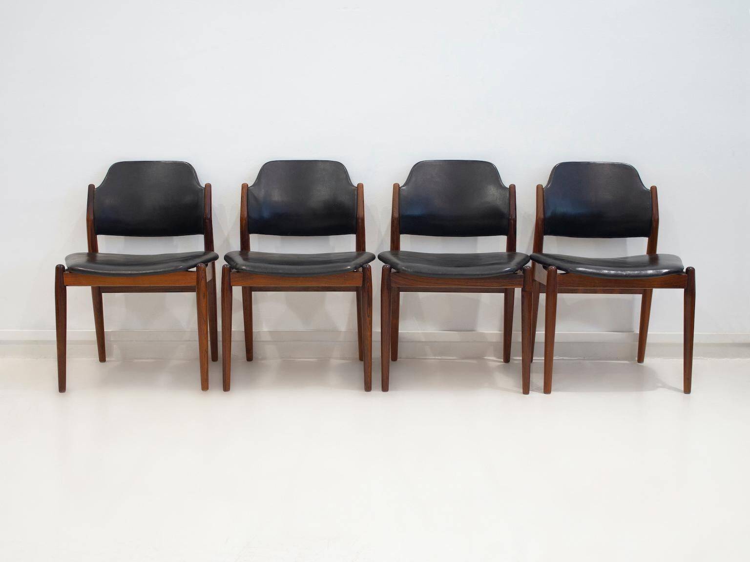 Set of four Arne Vodder chairs in hardwood and black leather.