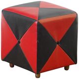 Mid-century ottoman stool in red and black faux leather with wooden legs.