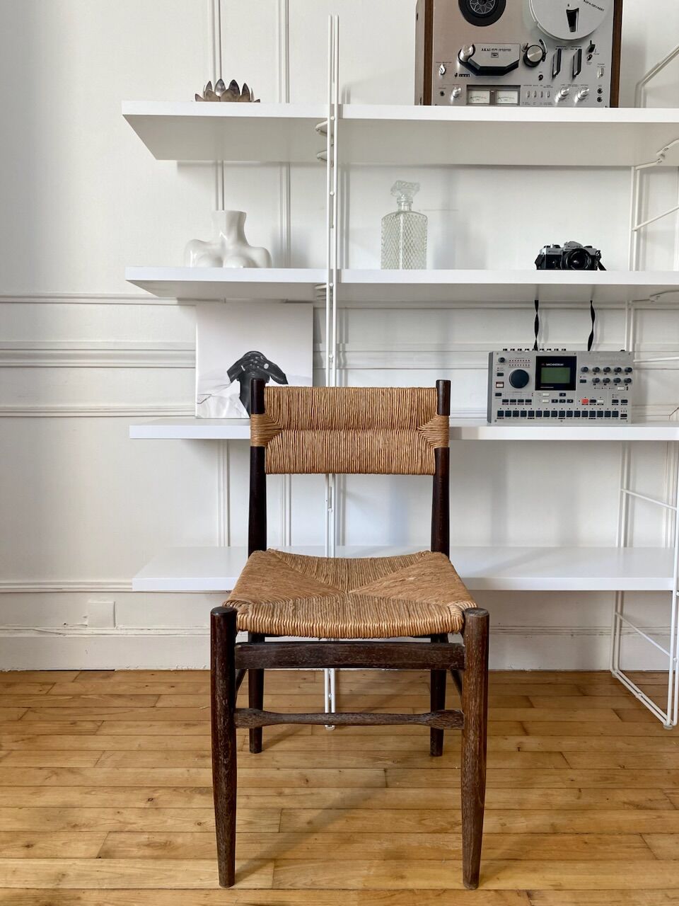Wooden chair and brutalist straw