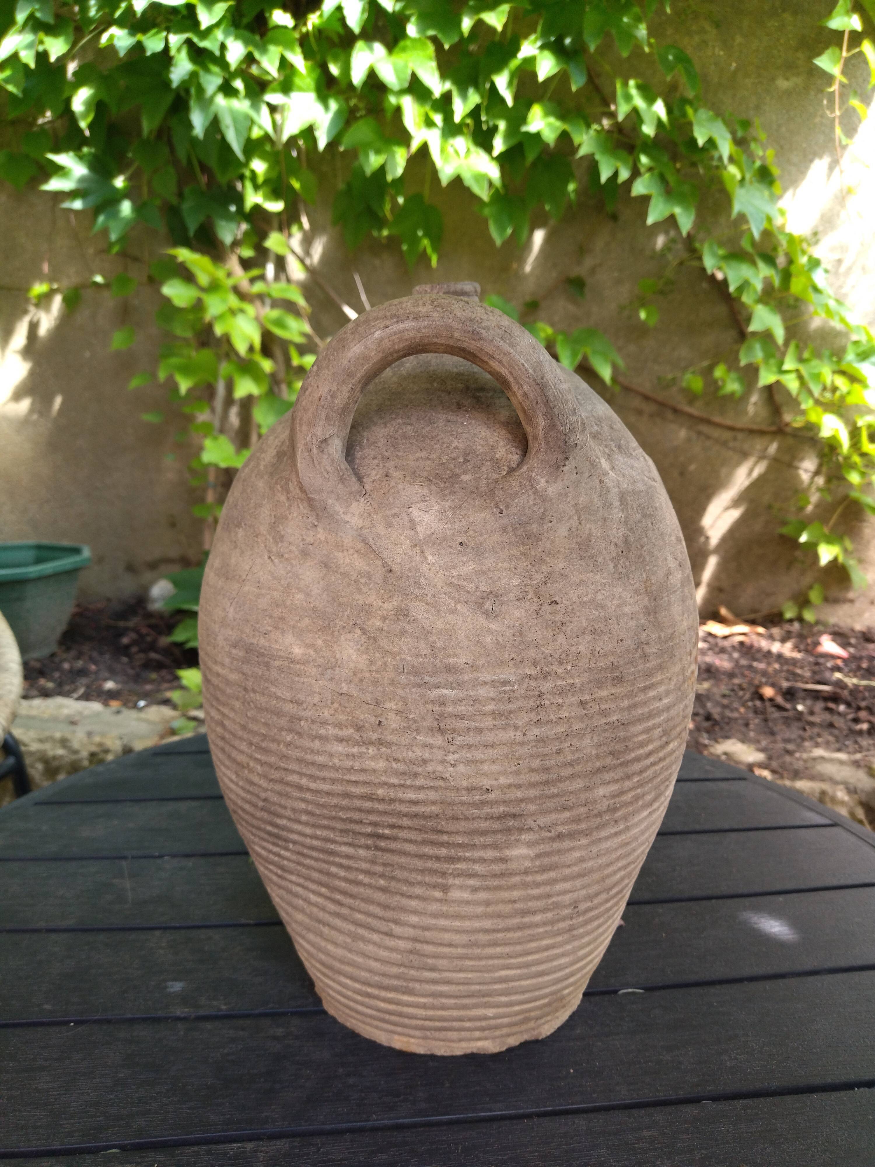 Ancient sandstone jar with two handles