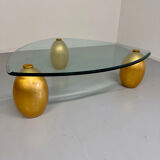 Vintage Italian design coffee table with a glass top and gold base, dating from the 1980s.