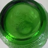 Green glass vase decorated with bunch of grapes and fruits