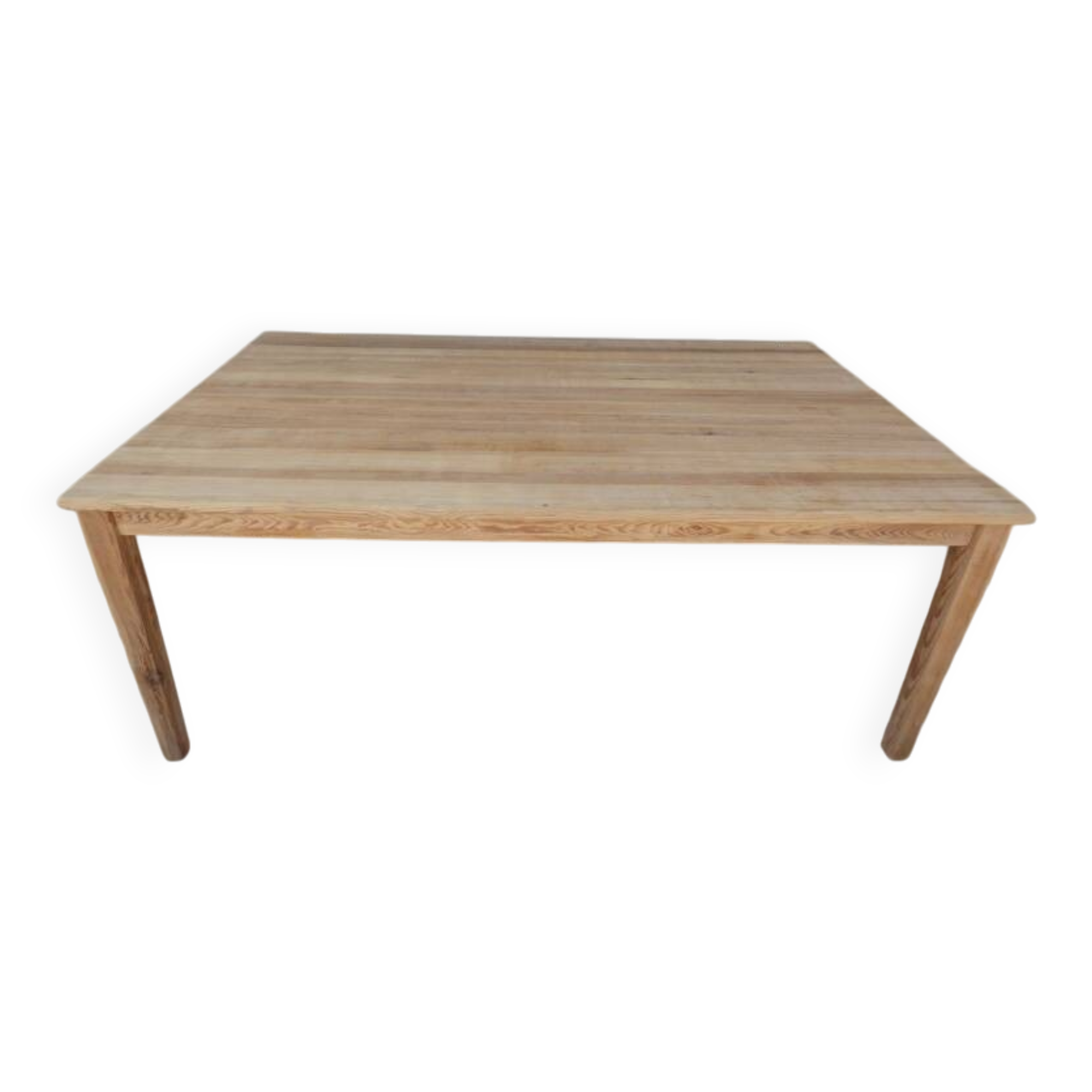Large natural wood table with rectangular top supported by legs