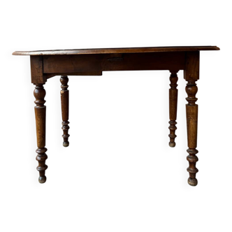 Round wooden drop-leaf table