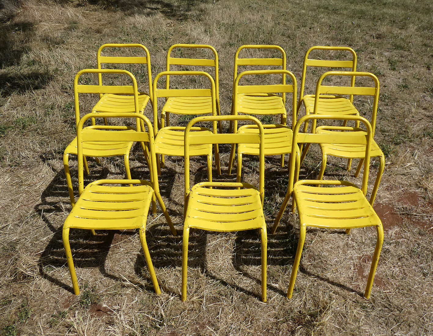 Lot of 11 yellow metallic bistro chairs from the 1950s