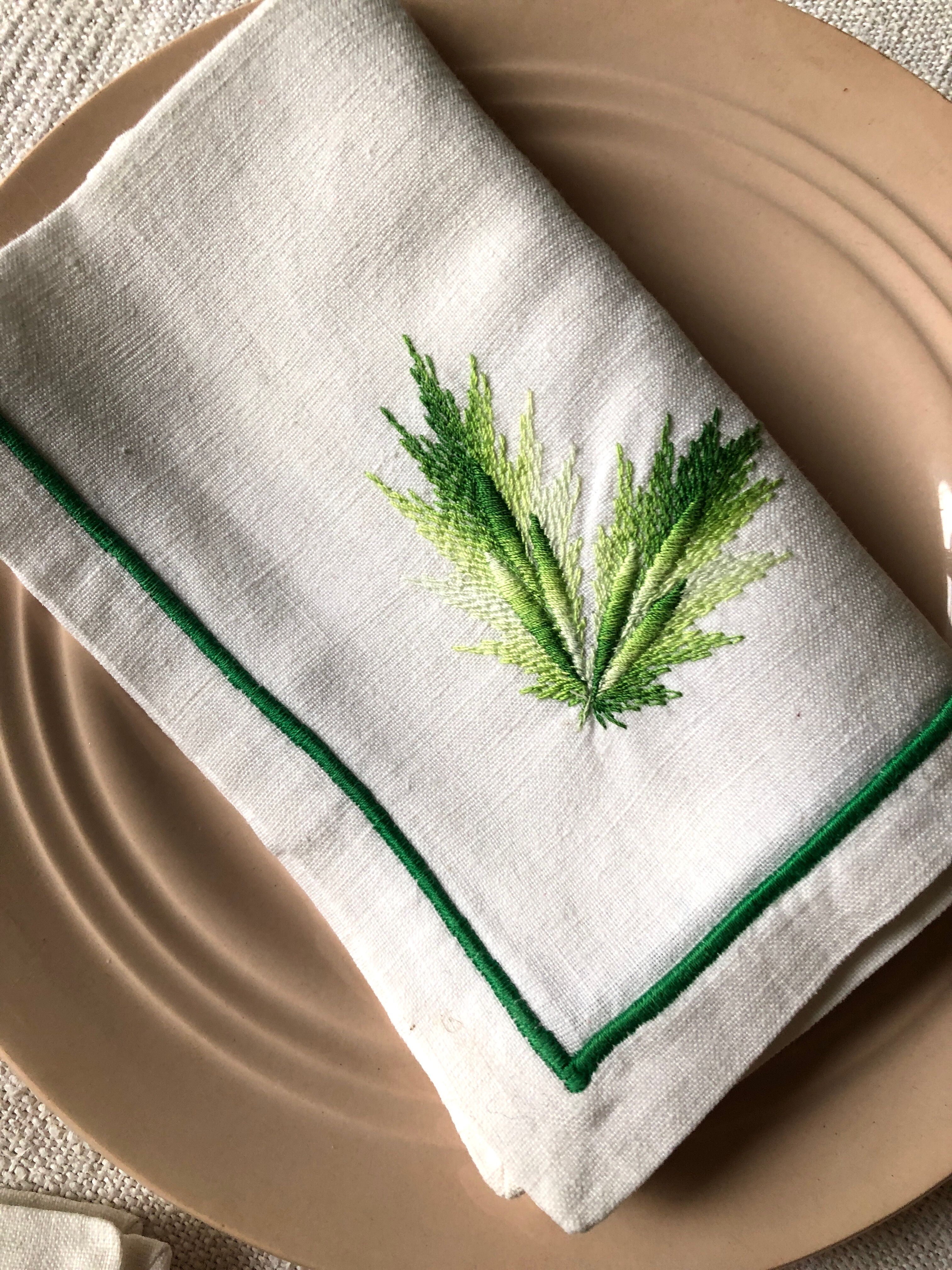 Series of four embroidered linen napkins