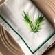 Series of four embroidered linen napkins