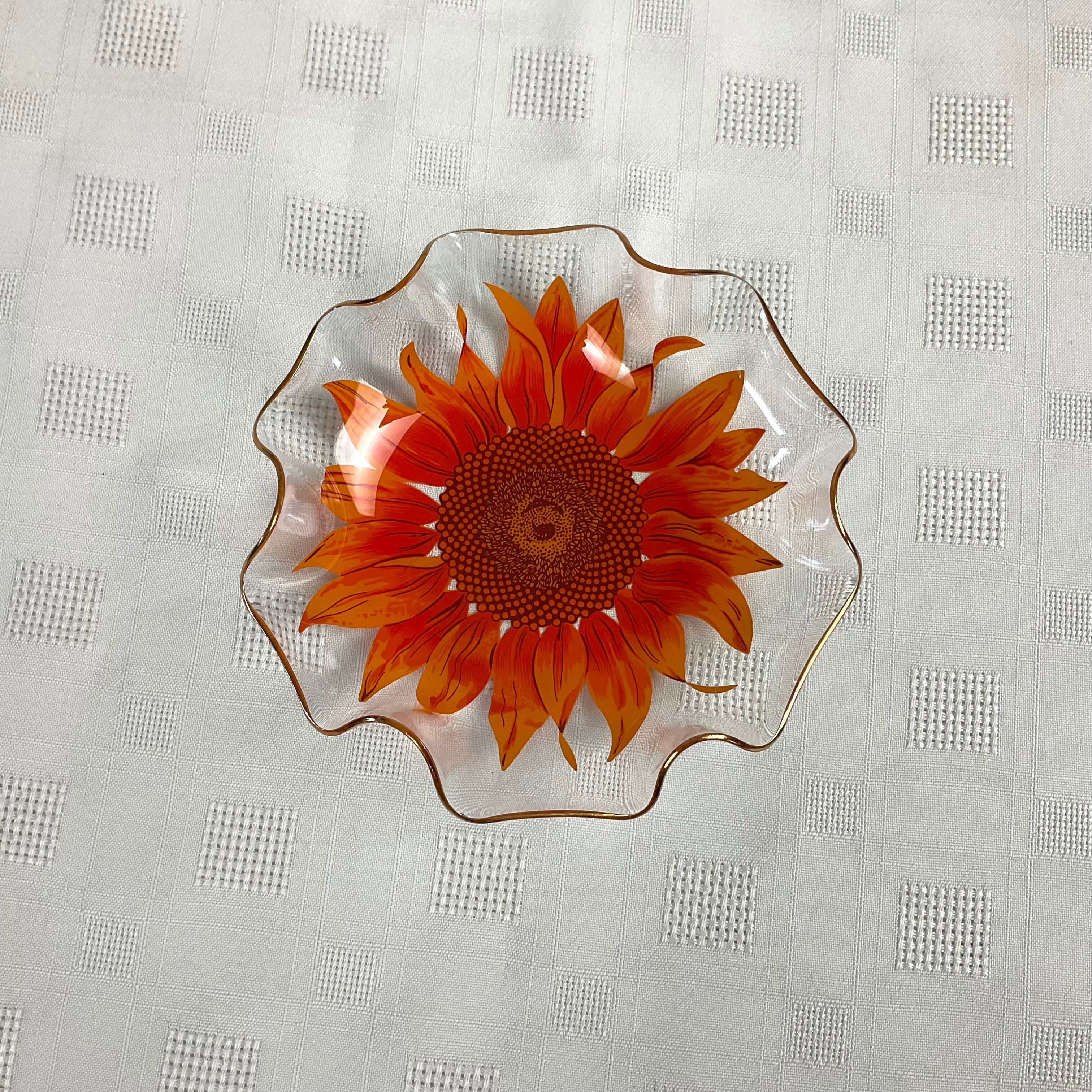 Glass cup with orange sunflower