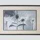 Framed painting with gray flower decor.