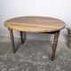 Antique wooden drop-leaf table with turned legs.