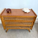 Vintage commode with tapered legs in rattan.