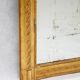 19th-century patinated mirror with a ribbon-style frame