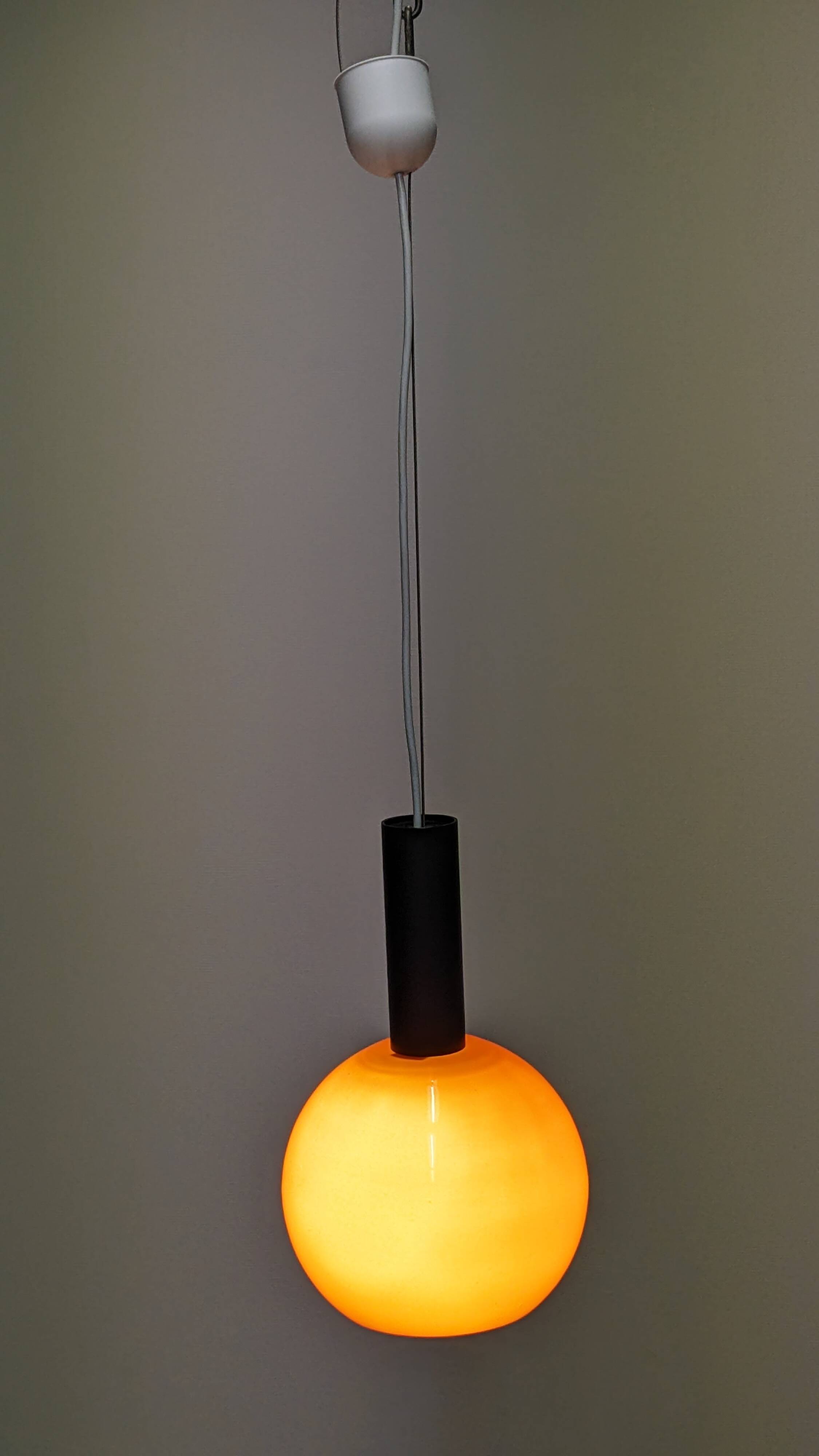 Pair of orange opaline ball pendants by Parscot, France circa 1970.