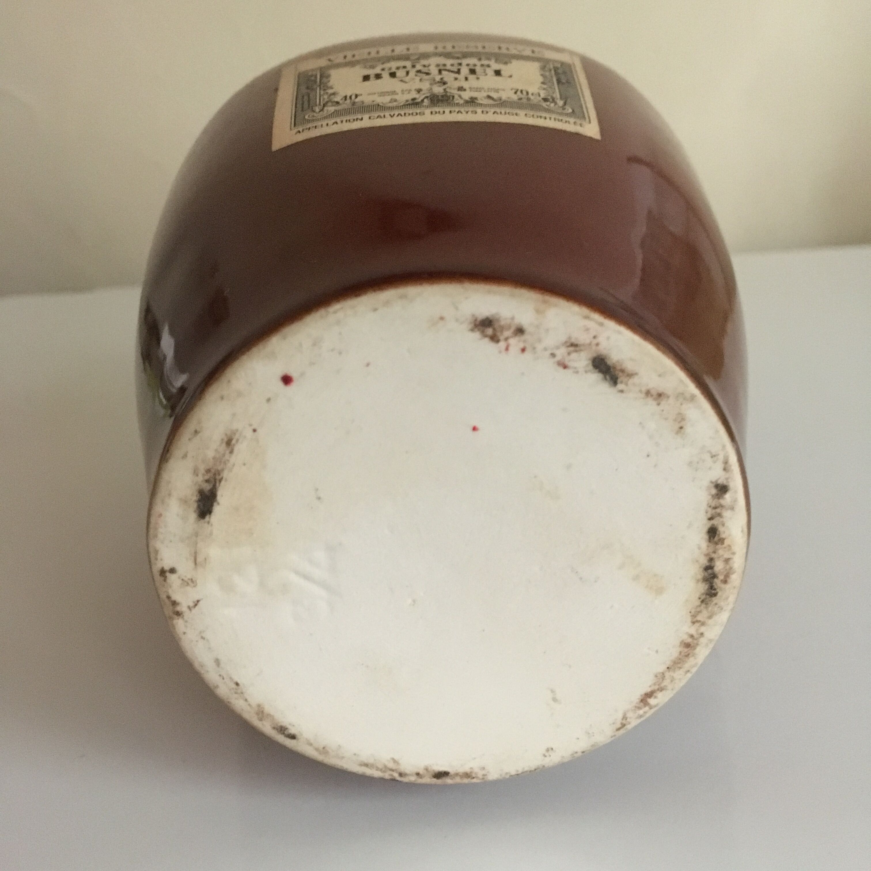 Old bottle of Calvados in sandstone