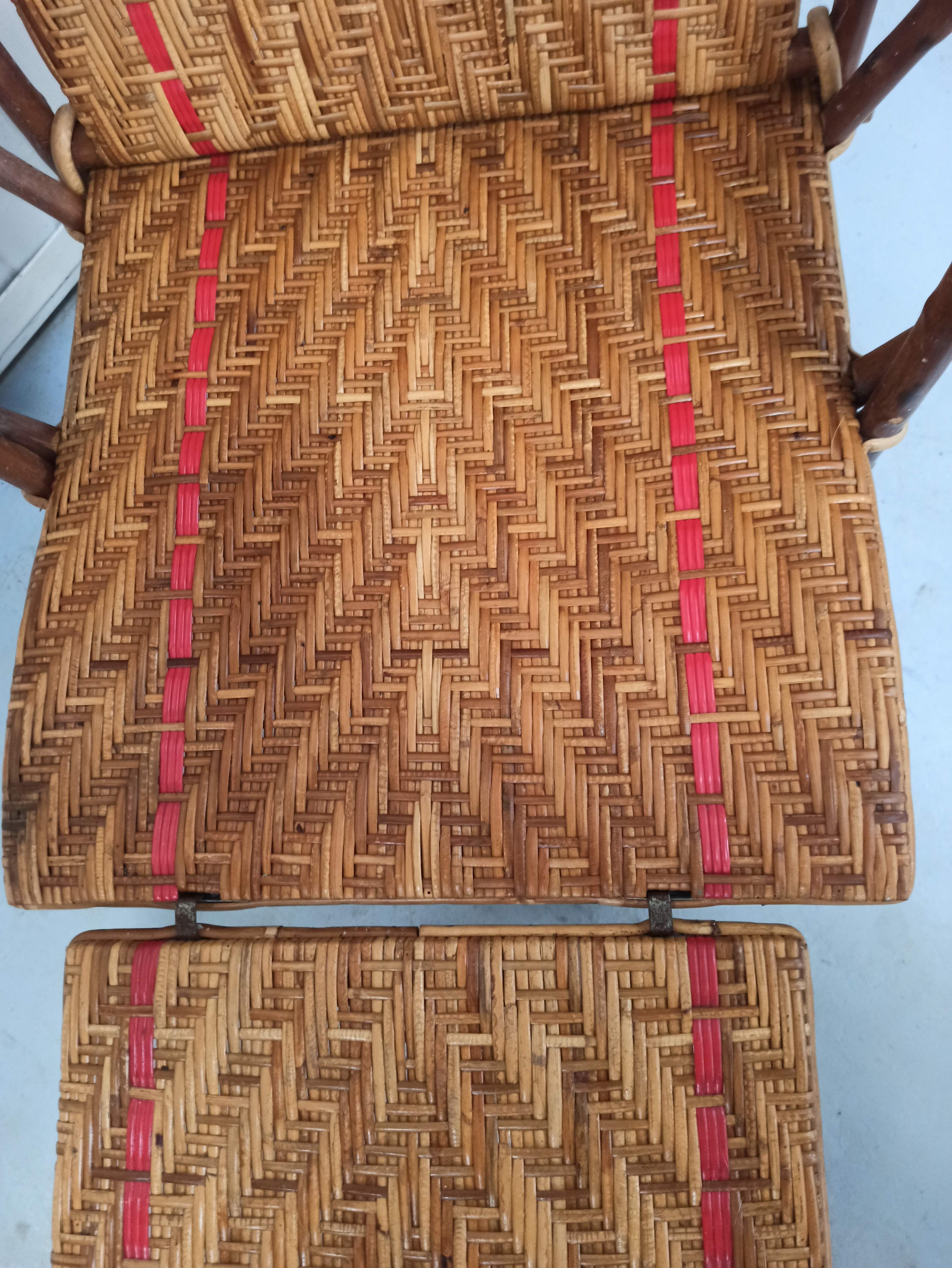Sunbathing sunbathing in wicker rattan wood deckchair red lounger