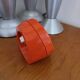 Vintage mechanical alarm clock in orange plastic Uti West Germany