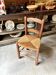 Provençal chair in dark wood and woven straw.