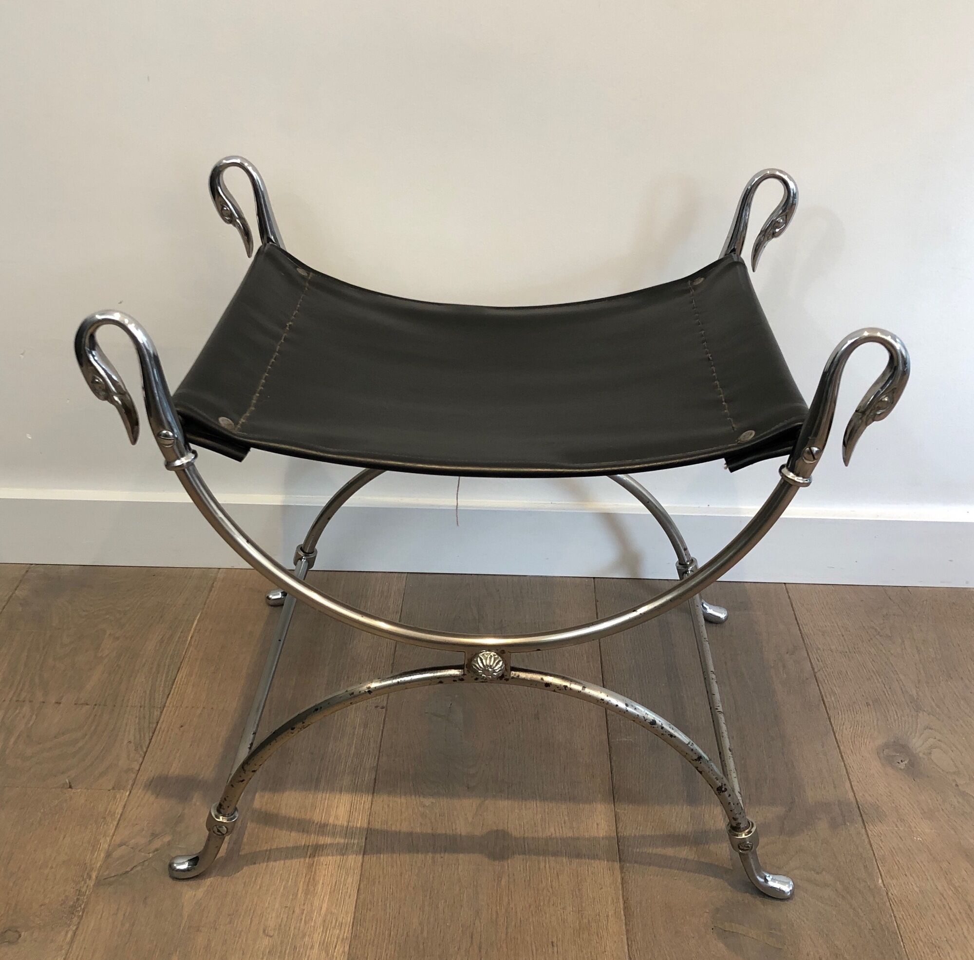 Curule stool in silver steel neoclassical style with swan heads