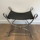 Curule stool in silver steel neoclassical style with swan heads