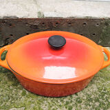 Old oval casserole in orange enamelled cast iron