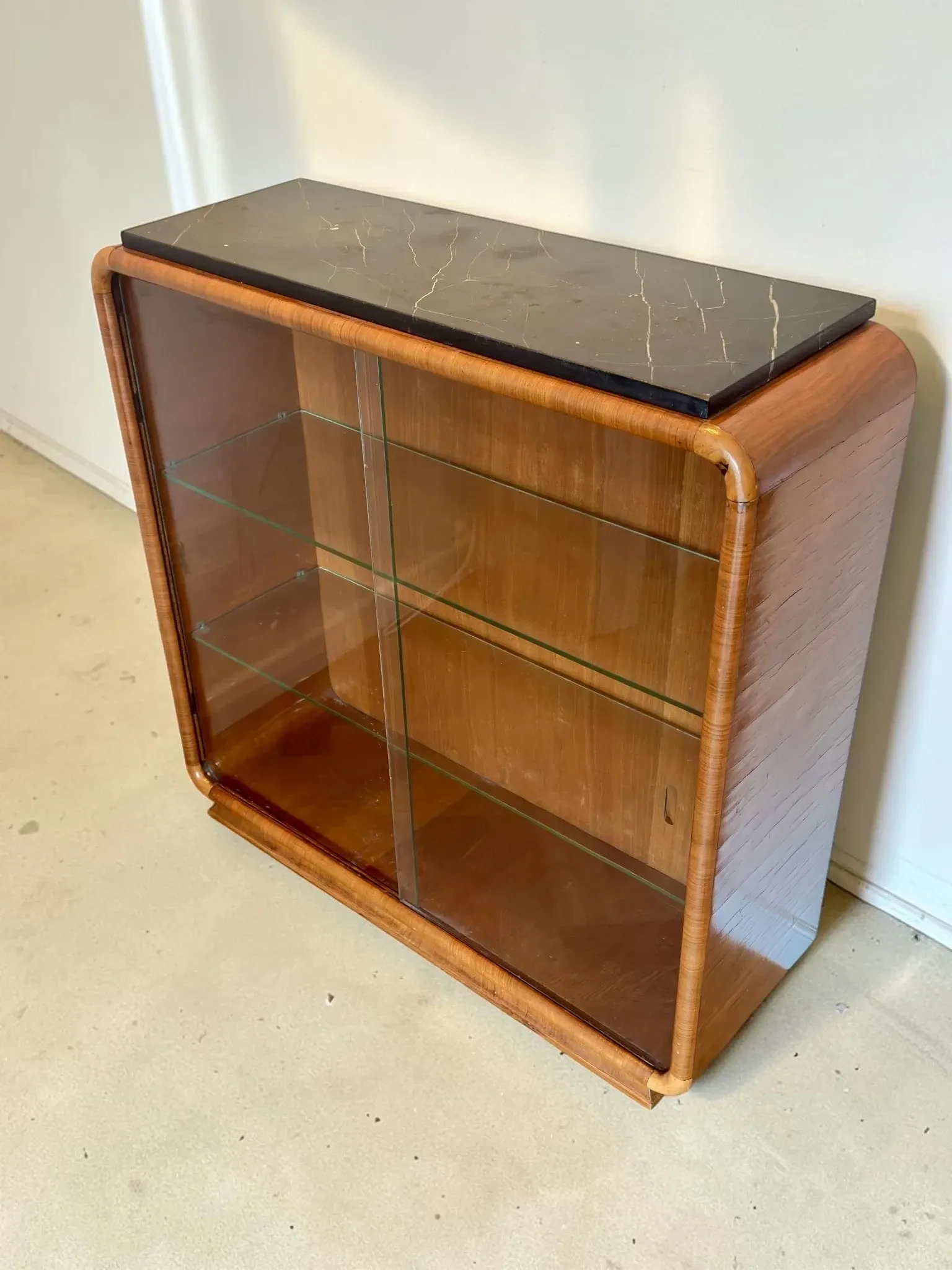 Vintage Art Deco display cabinet in mahogany with a black marble top.