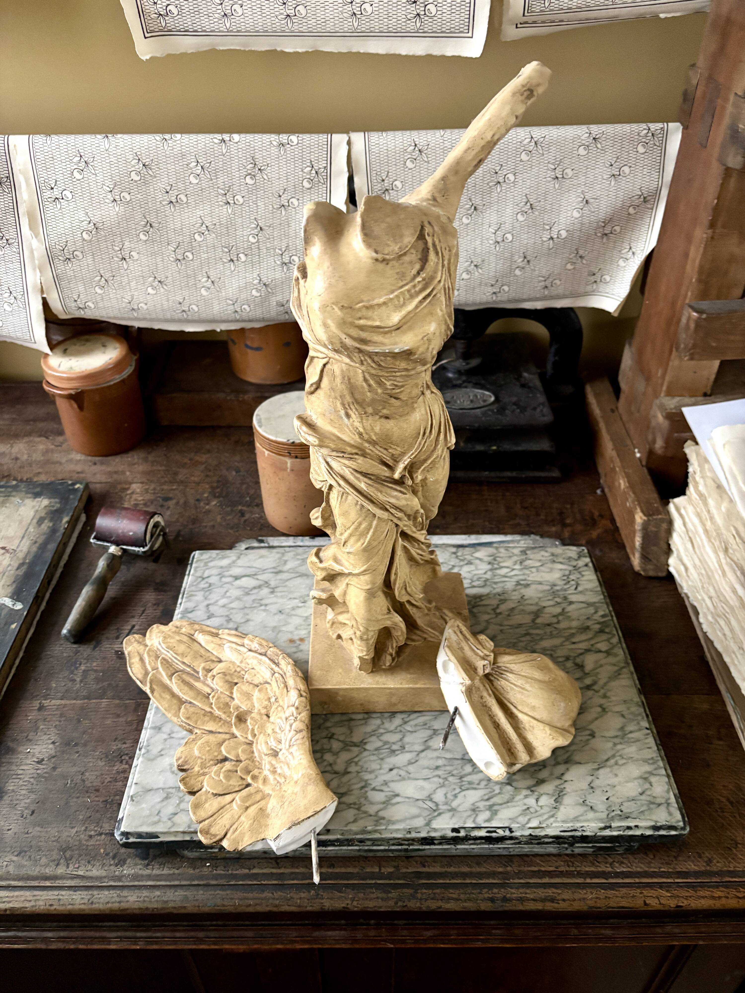 "Winged Victory of Samothrace", beige plaster statuette