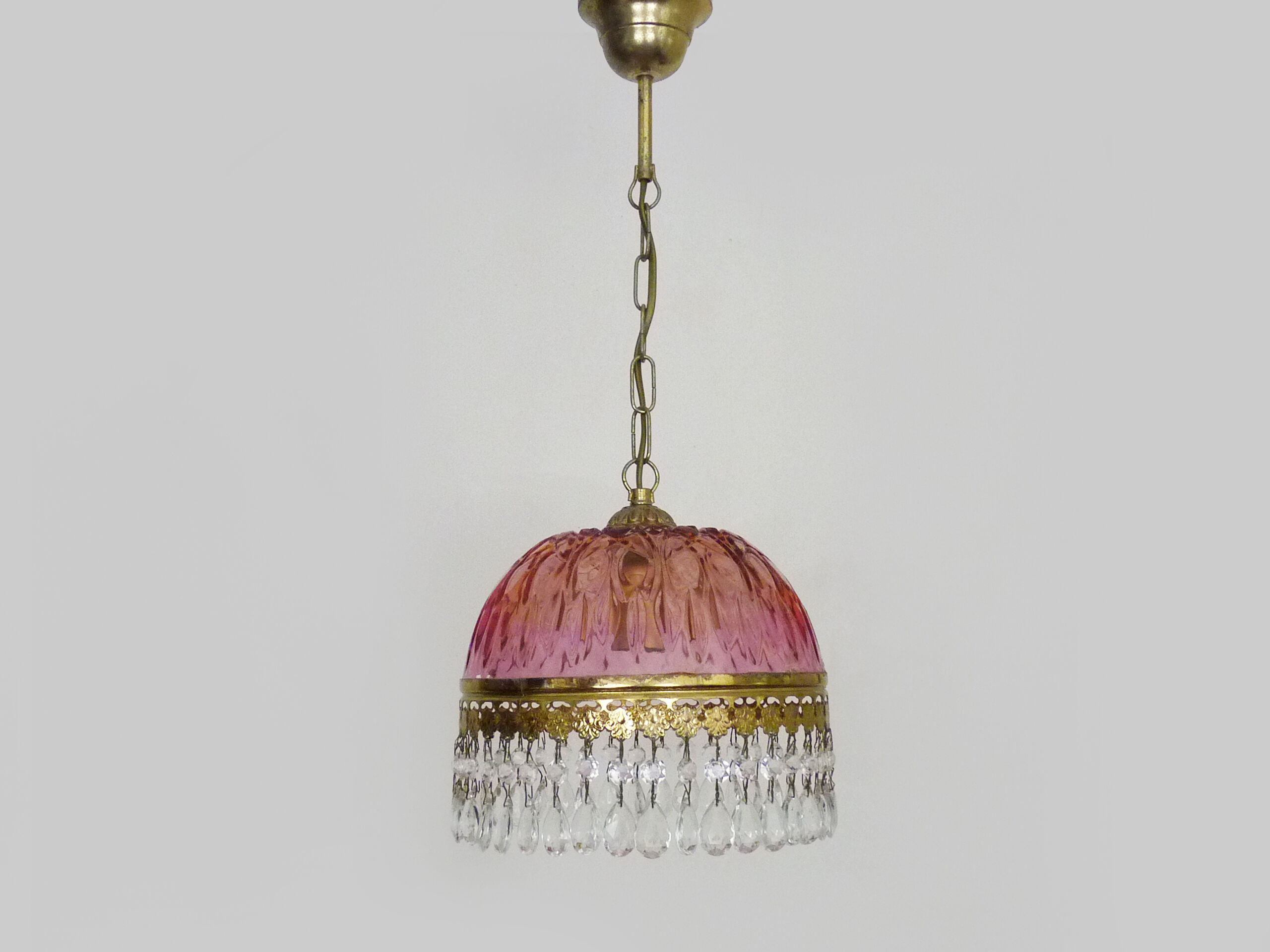 Vintage rose pendant light with pendants and patterned glass globe.