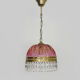 Vintage rose pendant light with pendants and patterned glass globe.