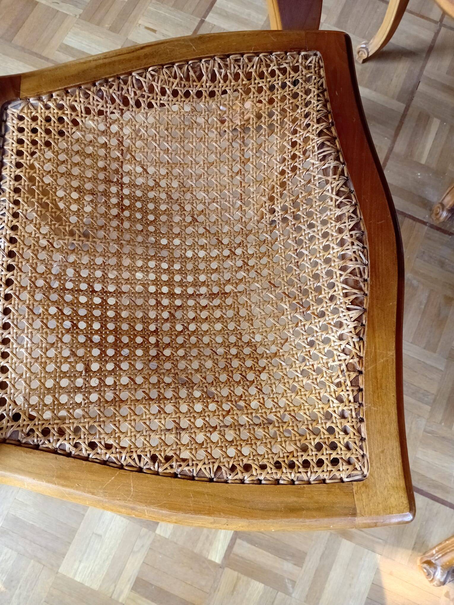 Carved wooden dining table and its 5 rattan caned chairs.