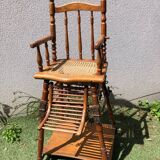 Old baby high chair in wood and canework