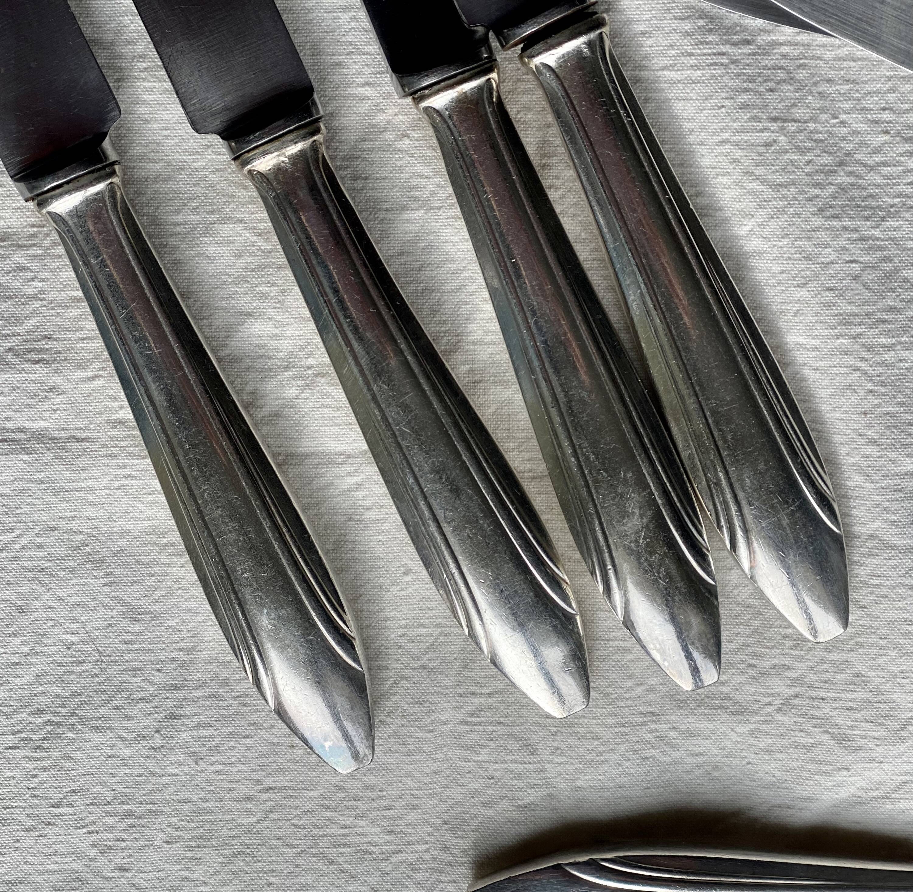 Set of 10 modernist silver-plated metal table knives.