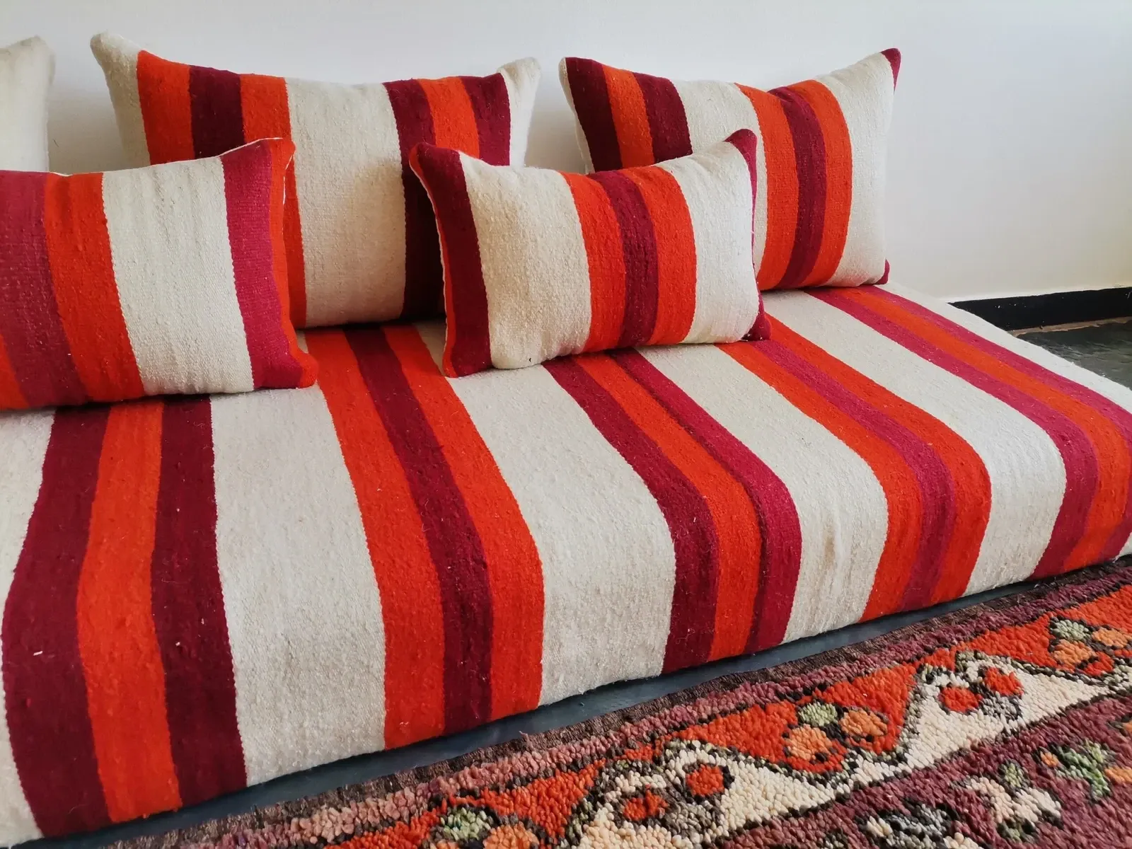 Set of covers for cream and red Moroccan floor sofa.