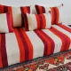 Set of covers for cream and red Moroccan floor sofa.