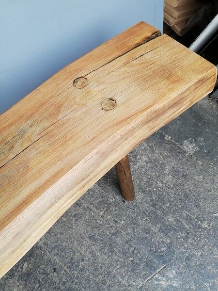 Big bench in solid rough wood very thick Brutalism