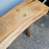 Big bench in solid rough wood very thick Brutalism