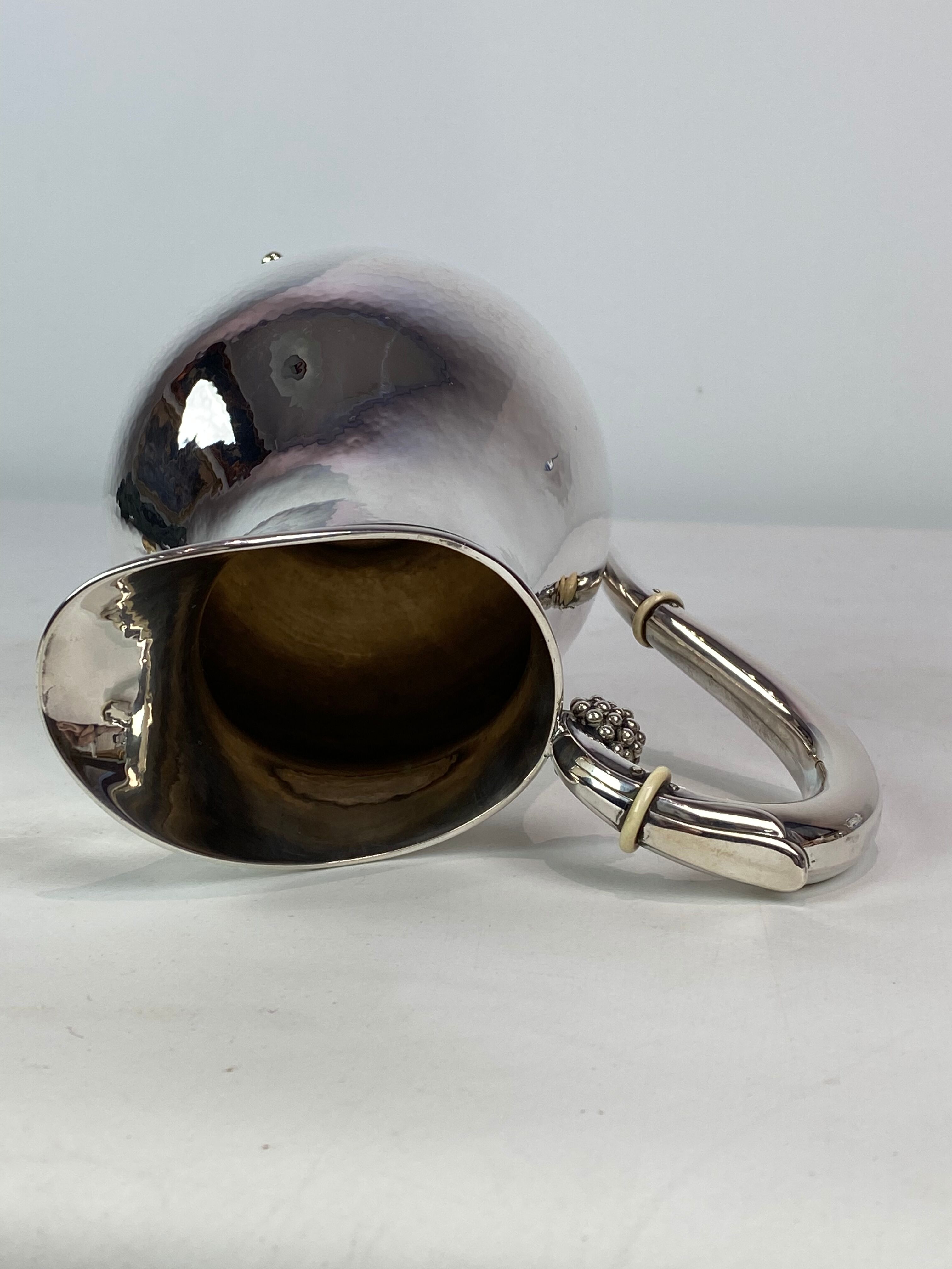 Water jug on feet decorated with ebony of hallmarked silver from the 1940s. The jug is in great anti