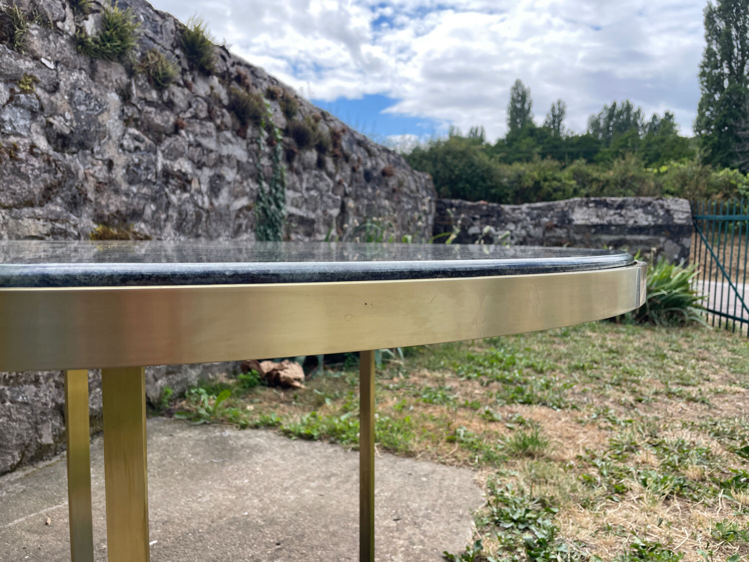 Round dining table with green marble and solid brass.