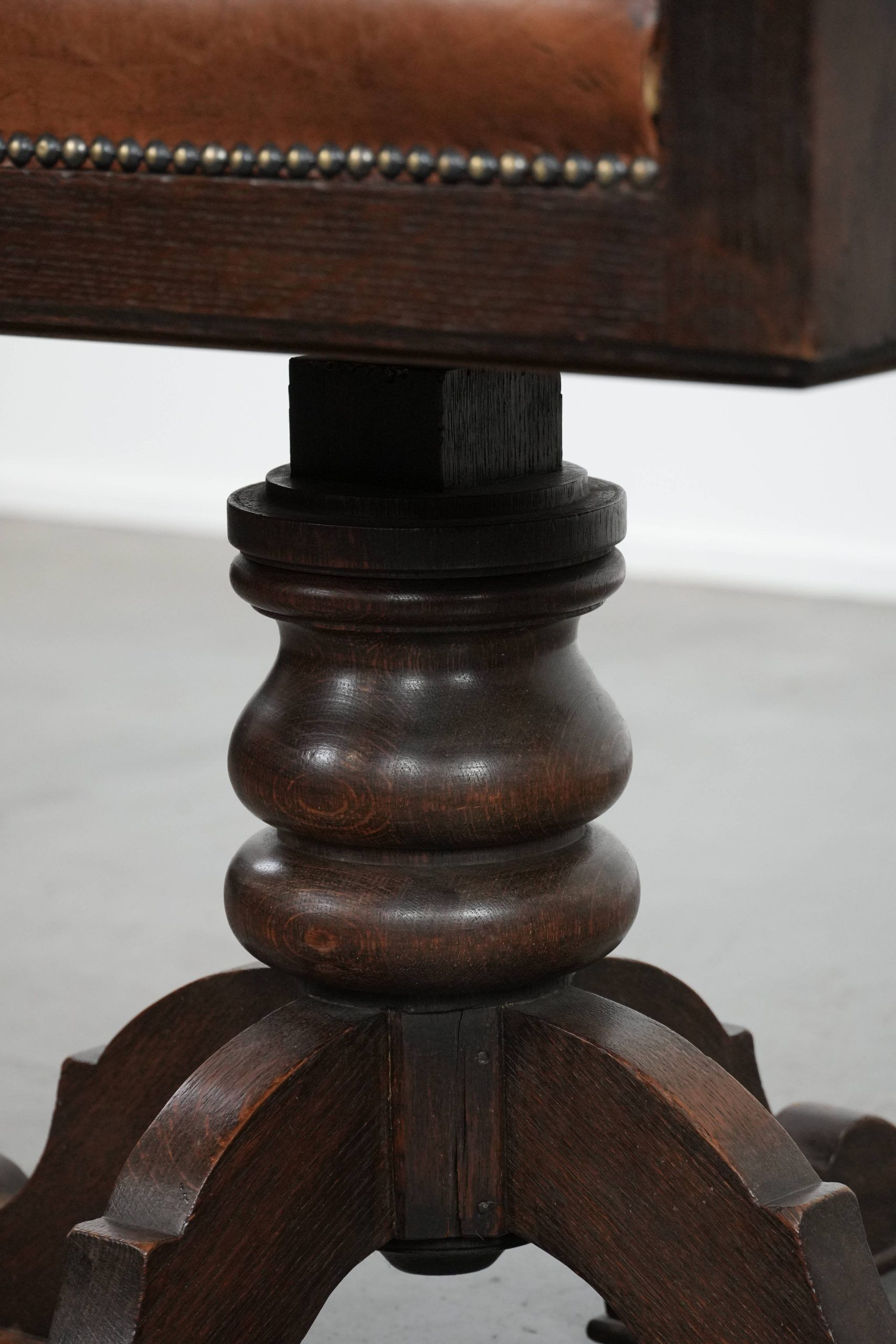 Elegant antique sheepskin leather desk chair with a heavy wooden frame