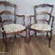 Pair of Provençal armchairs in brown wood and floral fabric.