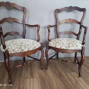 Pair of Provençal armchairs in brown wood and floral fabric.