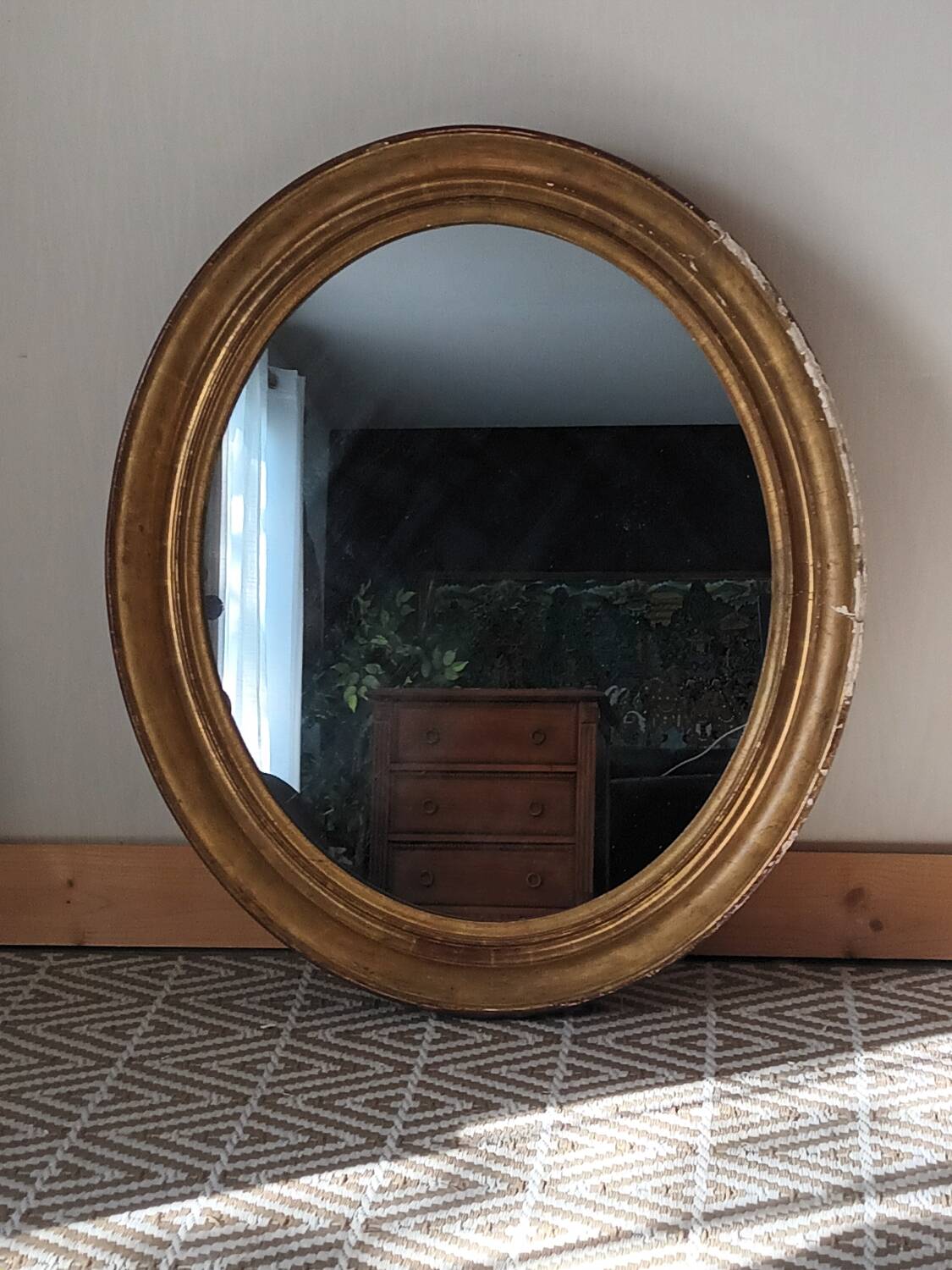 Antique oval gilded stucco mirror