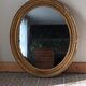 Antique oval gilded stucco mirror