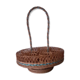 Glass holder and wicker bottle with green plastic water surface